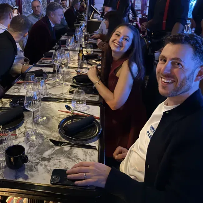 Build Concierge team sitting at a table during a winter event
